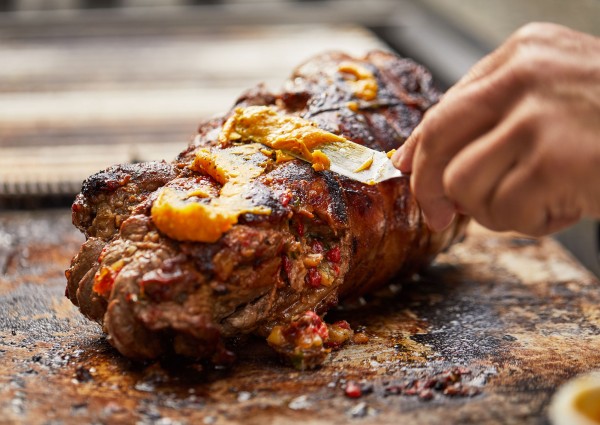 Basting the lamb with Moroccan butter